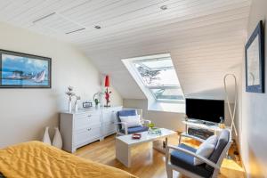 1 dormitorio en el ático con 1 cama y TV en Le Phare de Trézien, en Plouarzel