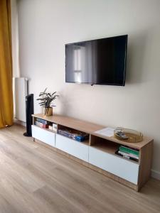a living room with a television on the wall at Apartament Centrum Białystok in Białystok
