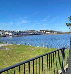 a view of a body of water with houses at Beachcomber in Garlieston