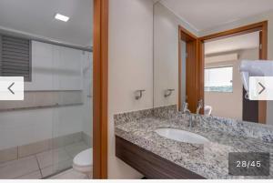 a bathroom with a sink and a toilet at Apartamento em Resort Olímpia in Olímpia