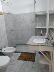 a bathroom with a shower and a sink and a toilet at El Jacal de San Pedro in San Pedro