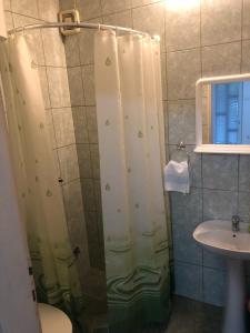a shower with a shower curtain in a bathroom at Apartmani Sunce in Bar +53 photos