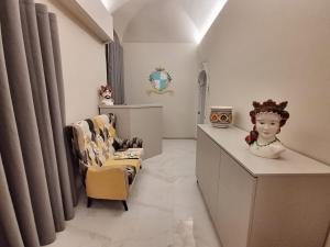 a dressing room with two chairs and a counter with a vase at That's Amore Accommodation Tropea in Tropea