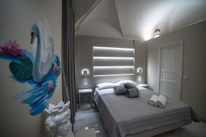 a bedroom with a bed with a swan on the wall at That's Amore Accommodation Tropea in Tropea