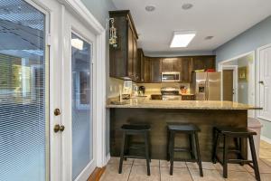 a kitchen with a counter and stools in it at Destination Destiny in Destin
