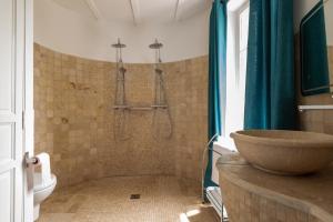 a bathroom with a shower with a sink and a toilet at Domaine La Tour - SPA - Jacuzzi - Sauna - Massage - 4 SAISONS - Piscine Chauffée Toute l'année - Heated POOL - 800m City Centre Nyons in Nyons