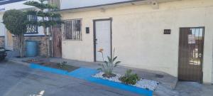 a house with a door and a plant in front of it at Departamento Ruze Rosarito Privado-Tranquilo in Plan Libertador