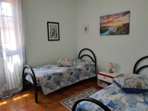 A bed or beds in a room at Villa dei Ginepri