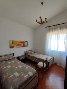 A bed or beds in a room at Villa dei Ginepri