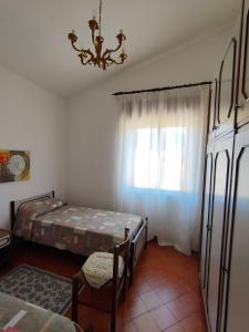 A bed or beds in a room at Villa dei Ginepri