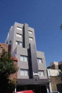 a tall gray building in a city at Novum Suites in Córdoba