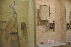 a bathroom with a shower with a sink and a mirror at Ida Chambres d'hôtes B&B in Montpellier