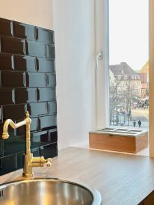 a sink in a kitchen with a window with a view at Le Cathedral View Colmar - Centre Historique - Parking privé gratuit in Colmar