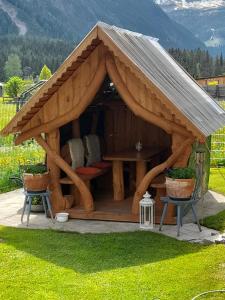 a gazebo with a table and chairs in a yard at Haus Sonnenschein in Holzgau