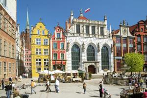a group of people walking in a city with buildings at Villa Lido in Gdańsk