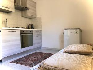 a small kitchen with a refrigerator and a stove at Relax Maratea in Maratea
