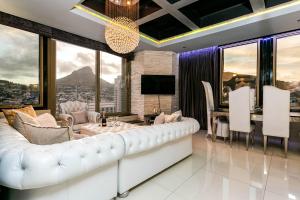 a living room with a white couch and a table at #2004 Cartwright - Glimmer Shimmer in Cape Town