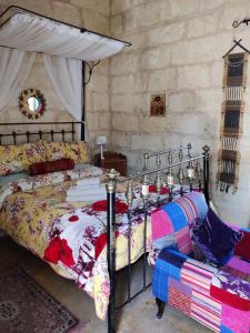 a bedroom with a bed with a canopy at The Garden Gate in Sannat