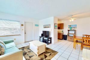 a living room with a couch and a table at The Simple Life in Cocoa Beach