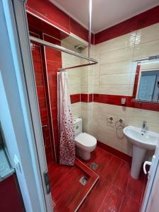 a bathroom with a toilet and a sink at Royal Palace in Olympic Beach +32 photos