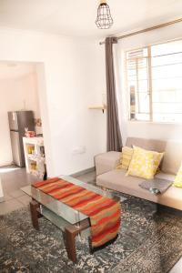 a living room with a couch and a table at Lovely 1-bedroom flat in Germiston in Germiston