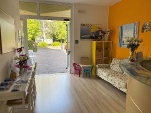 a living room with a couch and a table at Hotel ai Fiori in Grado