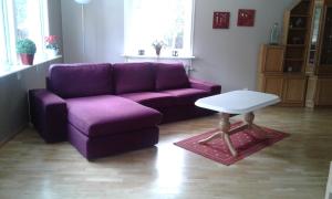 a purple couch and a table in a living room at Villa Polarktis in Överkalix