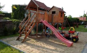 a playground with a slide and a play house at Noclegi u Pioruna in Ryn