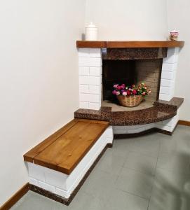 a brick fireplace with a bench in a room at La Finestra su Spello in Spello