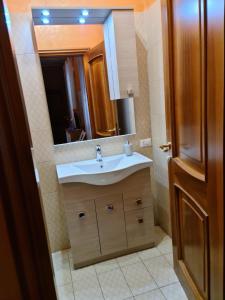 a bathroom with a sink and a mirror at La Finestra su Spello in Spello