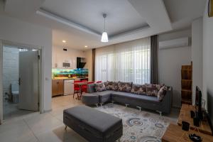 a living room with a couch and a table at Sare Suites Downtown in Antalya