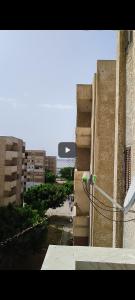 a building with a view of a street and buildings at شقه 115متر سوبر لوكس العامريه قريبه من الاسكندريه10min from Alexanderia in ‘Izbat al Musta‘marah +9 photos