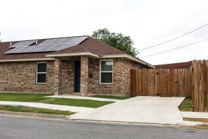 a house with solar panels on the roof at Casa Roble. Downtown Brownsville in Brownsville