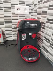 a black and red toaster sitting in a room at Appartement Fontargente in Ax-les-Thermes