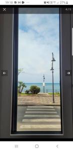 a window with a view of a street and the ocean at Una Finestra sul Mare in Maiori