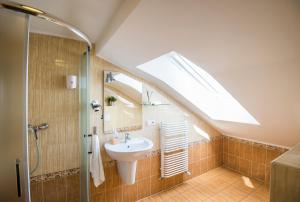 a bathroom with a sink and a skylight at H31 in Poznań