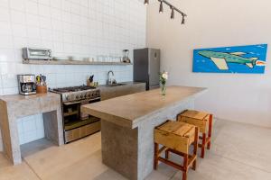 a kitchen with a counter and a sink and a stove at Topia Retreat- Sunset Suite in El Pescadero
