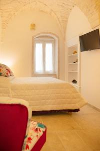 a bedroom with a large bed and a window at Le mie mani in Martina Franca