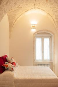 a bedroom with a bed and a window at Le mie mani in Martina Franca