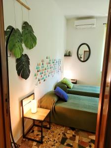 a bedroom with a bed and a table and a mirror at Lo Zizzolo- Bed&Breakfast in Marina di Campo