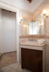 a bathroom with a sink and a mirror at Escape to Mykonos - Entire place by Ornos beach in Ornos +10 photos