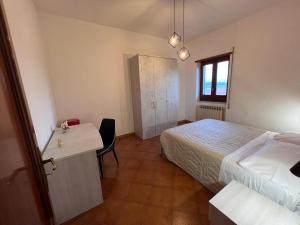 a hotel room with a bed and a desk and a bed at ATOMOS in Alvignano