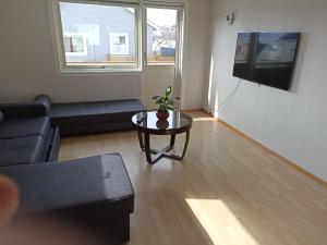 a living room with a couch and a table at FeelHome One bedroom apartment Vidarsveg in Tromsø