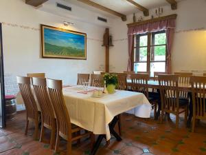 a dining room with a white table and chairs at Sobe Gondola Sotin in Sotin