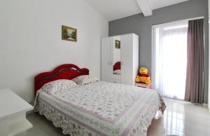 a bedroom with a large bed and a window at Apartment ANA in Bar