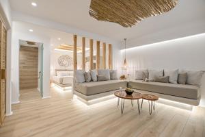 a living room with a couch and a table at Villa Adriana Hotel in Agios Prokopios