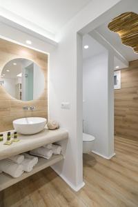 a bathroom with a sink and a mirror at Villa Adriana Hotel in Agios Prokopios