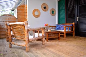 a patio with chairs and a table on a porch at Brise Marine in Sainte-Luce