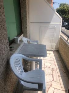 a table and two chairs on a patio with a table and a table at TEA Apartments in Pomorie