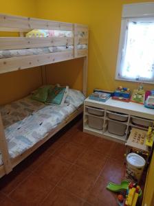 a bedroom with two bunk beds and a window at Nuestras Estrellas in Cabreros del Monte +14 photos